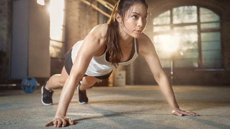 Young woman doing press-ups