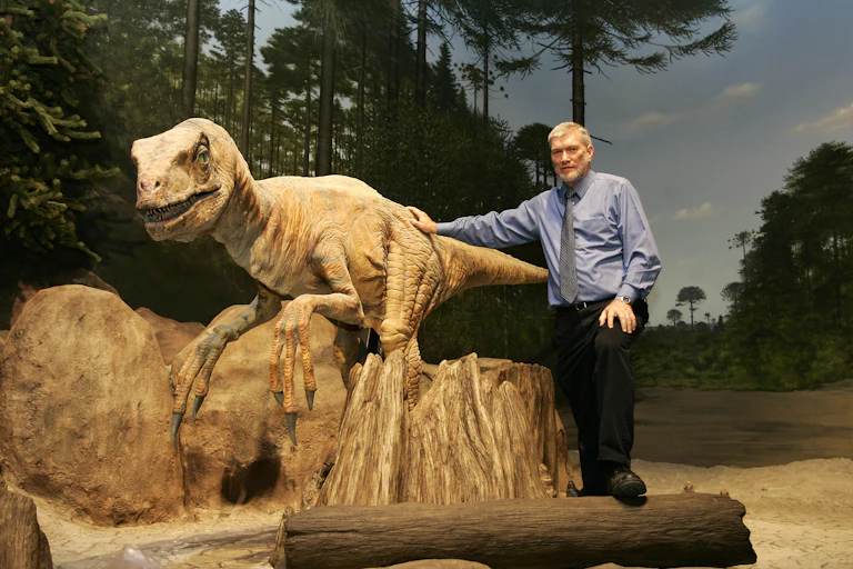 Man stands with robotic dinosaur