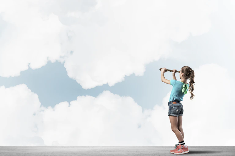 Little girl looking through telescope at clouds