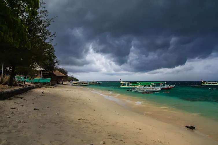 Thunderstorm clouds over tropical beach