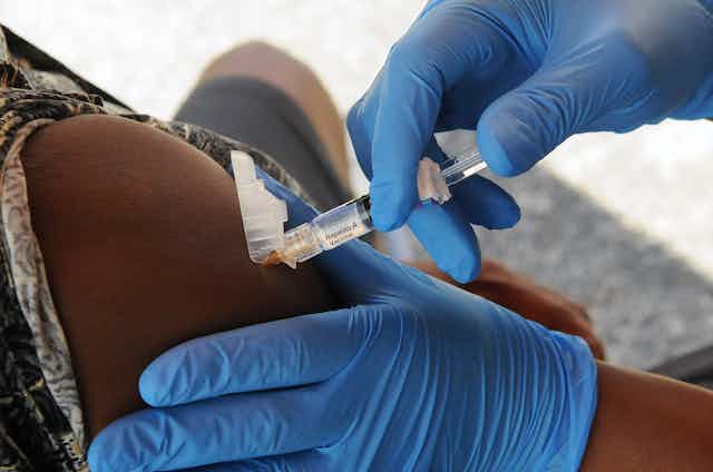 A nurse administers hepatitis A vaccine at a hepatitis A vaccination event.