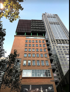 Apartment block converted from former telephone exchange and post office building at 118 Russell Street, Melbourne.