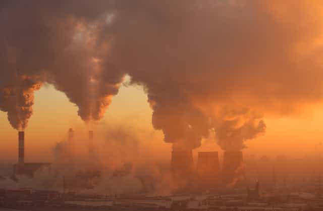 Pollution from a factory in dawn light.