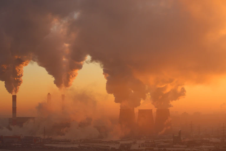 Pollution from a factory in dawn light.