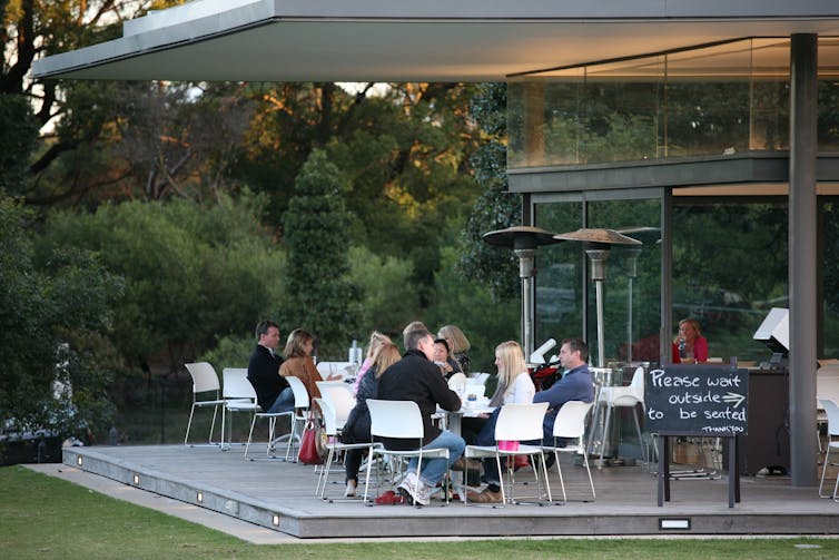 People sitting outside at a cafe.