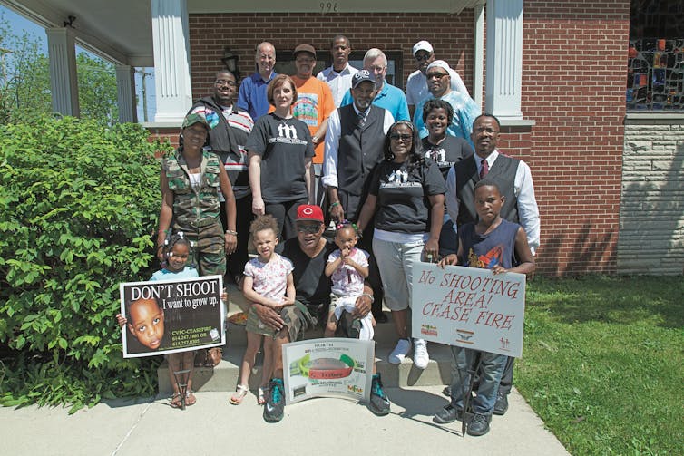 Group photo of people holding anti-violence signs