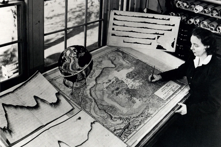Marie Tharp at work drafting a map at her desk