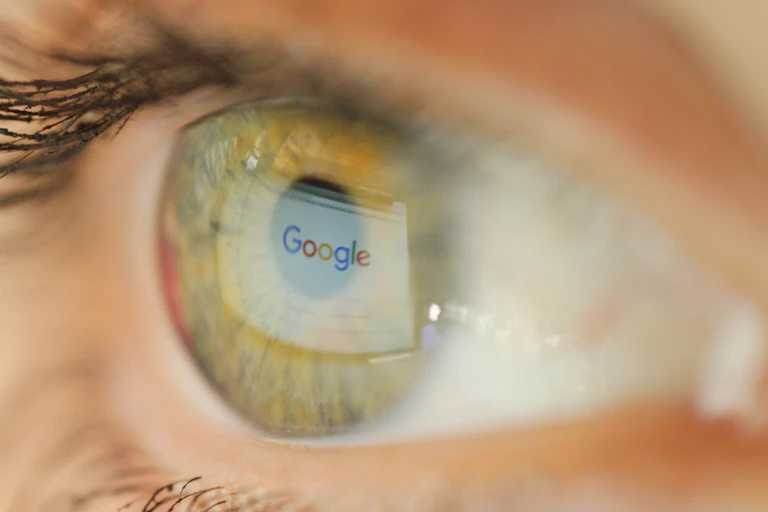 An eye with Google's logo reflected in it.