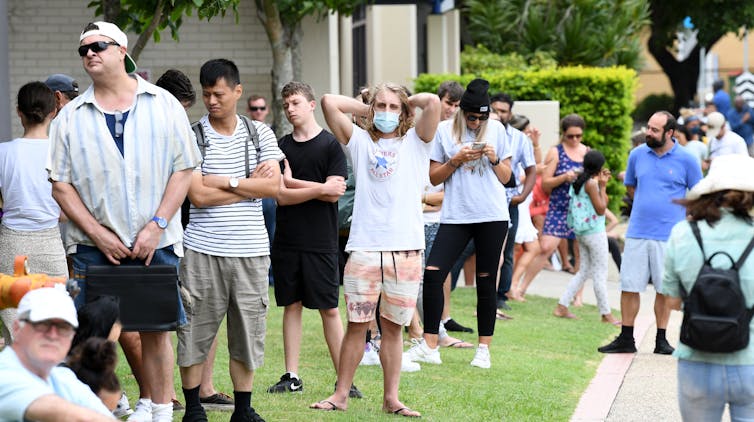 Long queue of Australians line up outside Centrelink office.