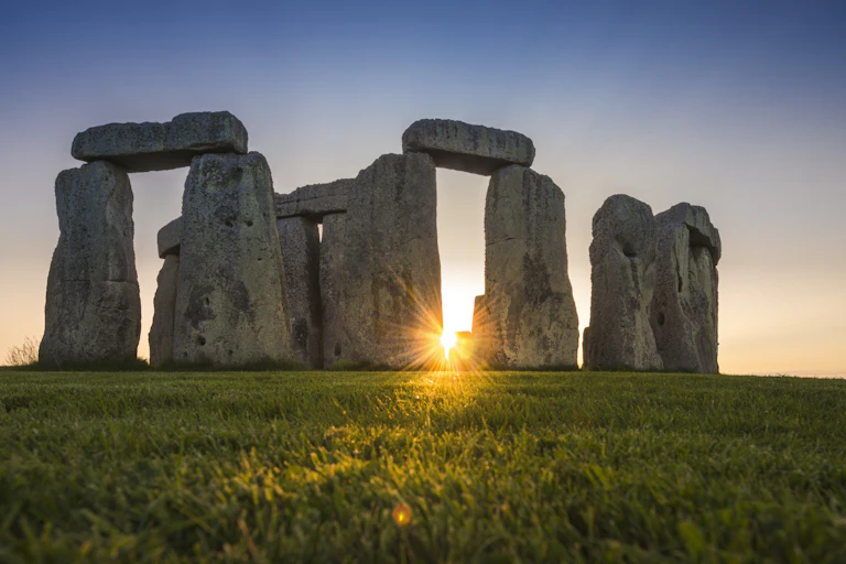 Central stones of Stonehenge at sunset.