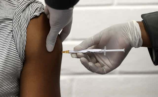 A volunteer receives the COVID-19 vaccine in South Africa