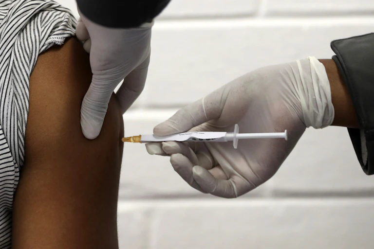 A volunteer receives the COVID-19 vaccine in South Africa