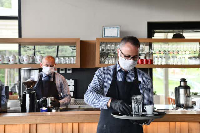 Two restaurant staff wearing masks