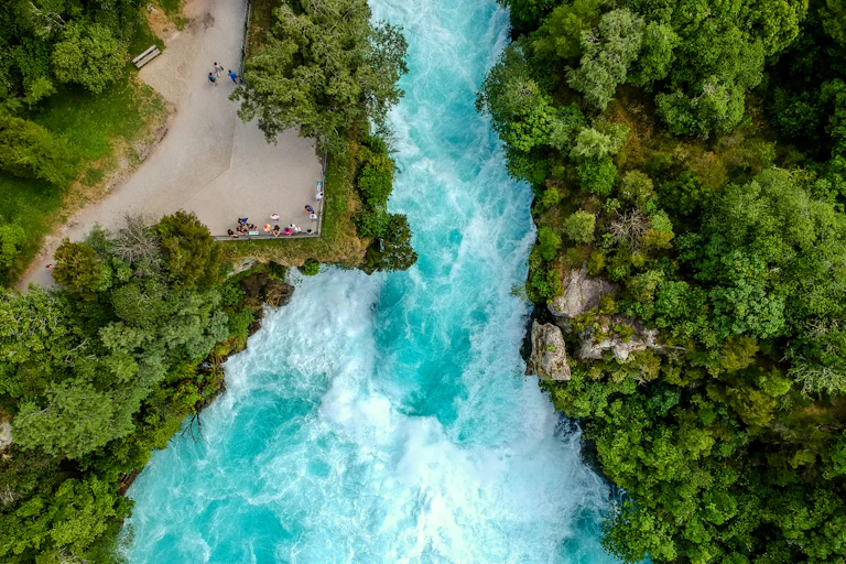 People on platform watching raging river