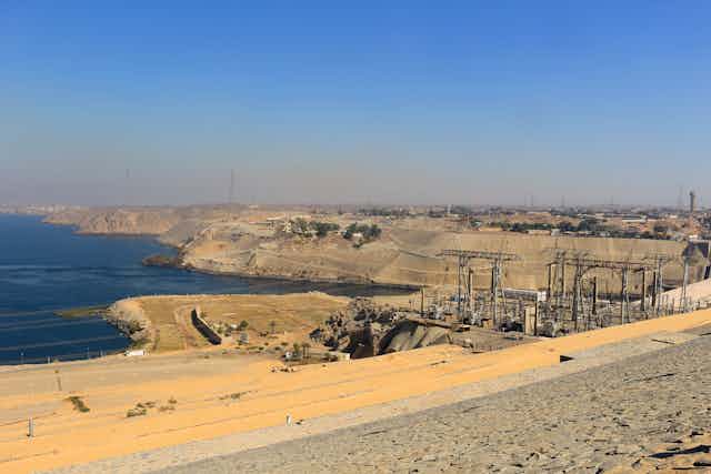 The High Dam in Aswan Egypt showing poles and power lines.