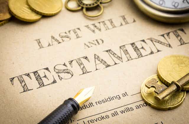 Last will and testament with coins, pen and key