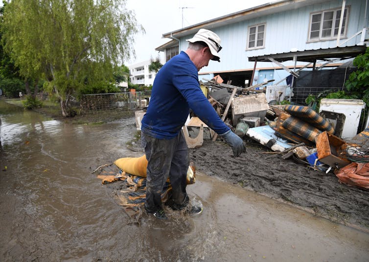 Man cleans up after Townsville flood