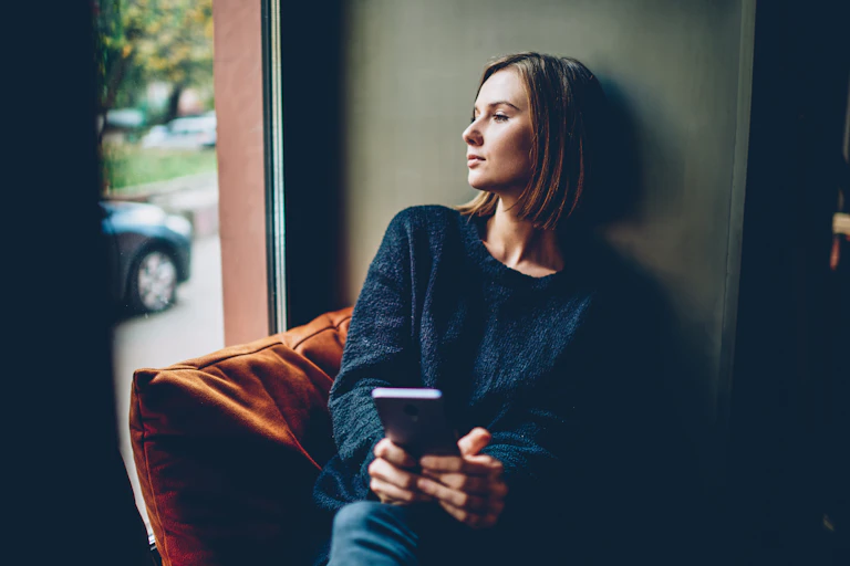 Woman looking out the window pensively