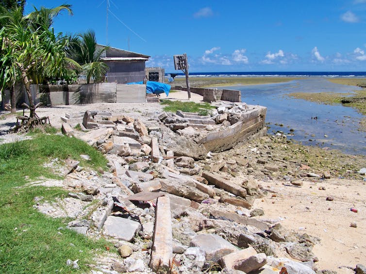 The ruins of a sea wall on a coastline.