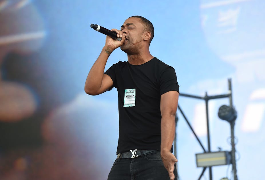 Grime artist Wiley performs on stage.