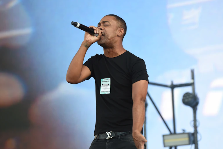 Grime artist Wiley performs on stage.