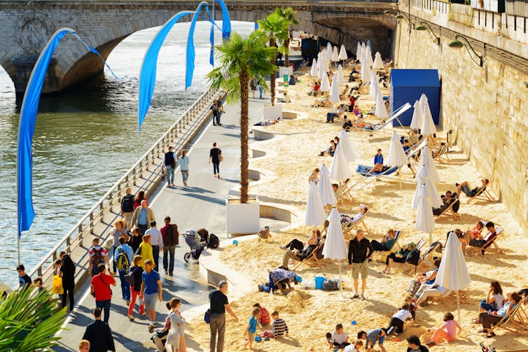 The Paris Plage – a sandy beach with potted palms overlooking the River Seine.