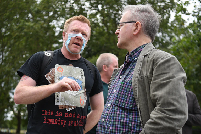 A man wears a broken facemask as a protest.