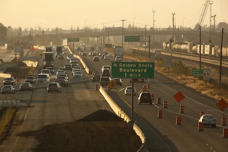 Cars on a highway in Fresno, Calif. under a hazy sky