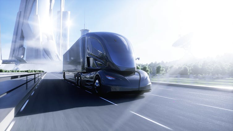 A futuristic electric truck on a highway near a city