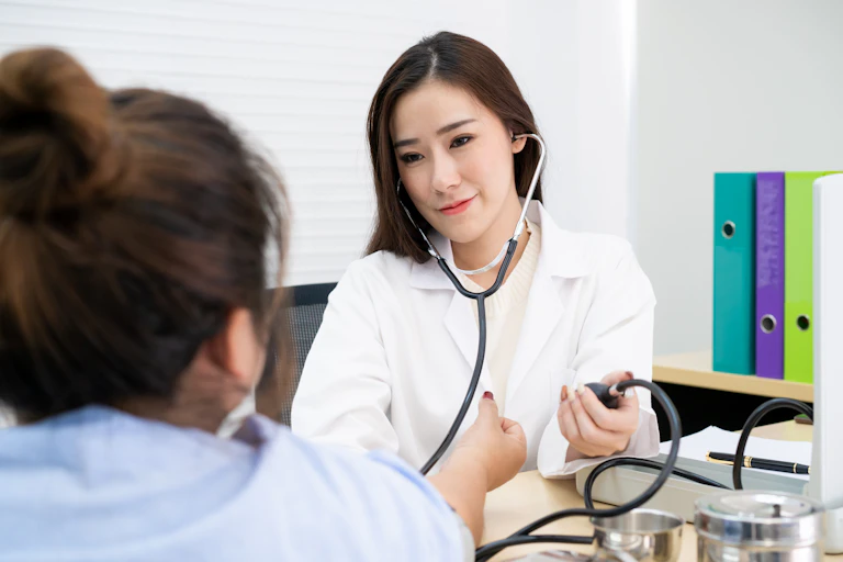 A doctor is taking her patient's blood pressure