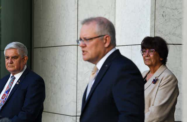 Minister for Indigenous Australians, Ken Wyatt stands with Prime Minister Scott Morrison and Aunty Pat Turner