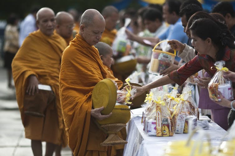 Buddhist monks have reversed roles in Thailand – now they are the ones donating goods to others