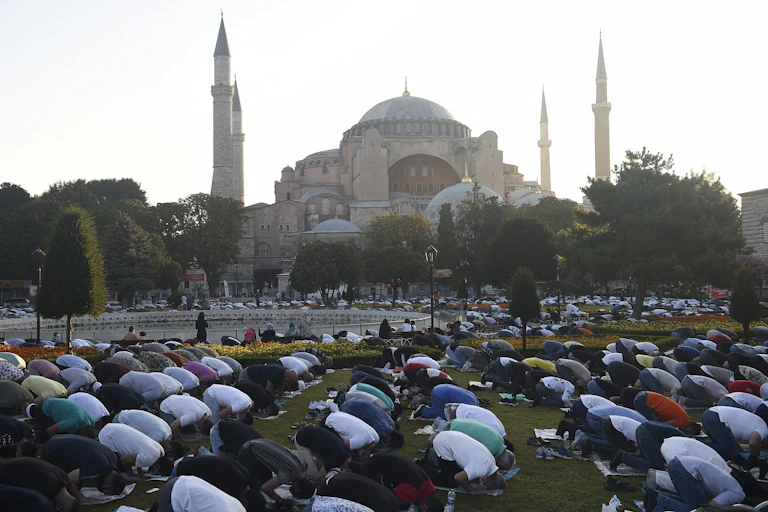 Muslims are seen praying outside Hagia Sophia.