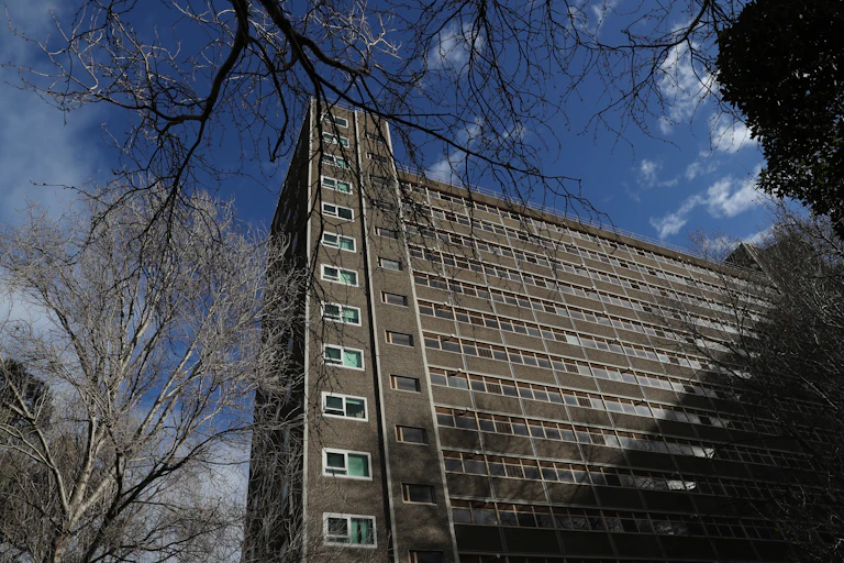 A high rise tower block with blue sky in the background.