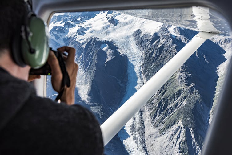A person taking an image of a glacier
