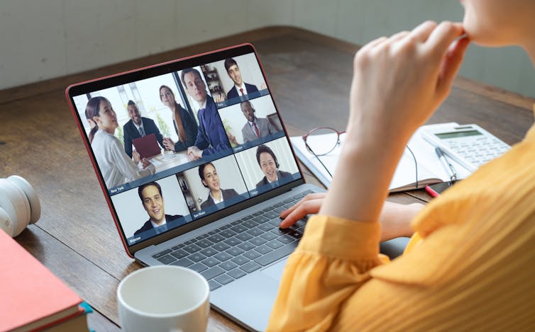 Woman with a laptop in front of her on a Zoom meeting