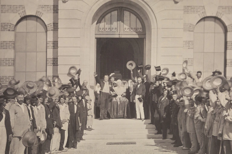 Hospital patients stood outside, raising their hats to celebrate a marble bust of Napoleon III.