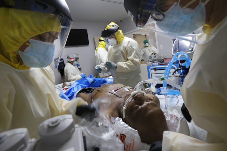 A Houston, Texas, medical team puts a patient on a ventilator.