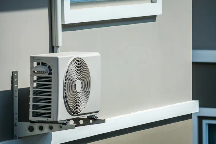 Air conditioner outdoor unit installed outside the house.