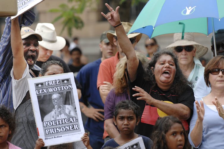 Protestors holding a sign that reads, 'Free Lex Wotton'