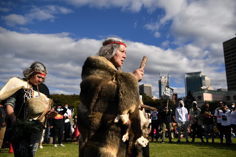 Protestors during a traditional smoking ceremony at a Black Lives Matter rally