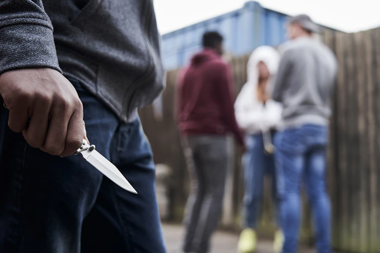 Teenage boy holding knife