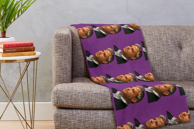 A throw draped over a couch, depicting Brett Sutton