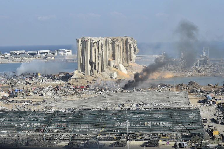 Landscape photograph showing ruined building and smoke