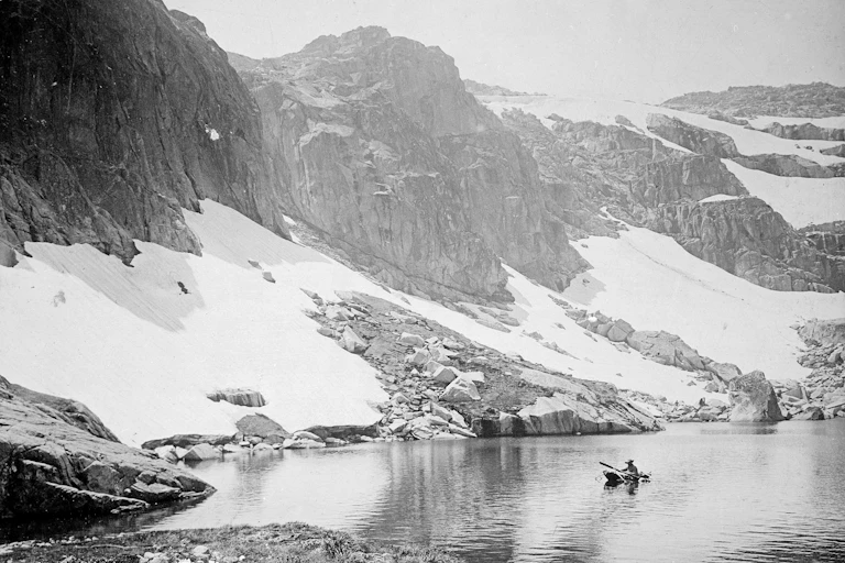 A man rows a boat on Blue Lake in 1906