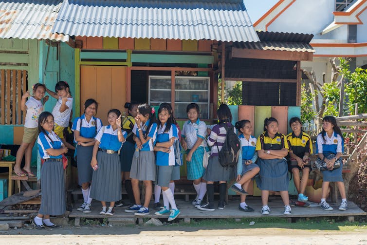 Indonesian schoolgirls outside a building