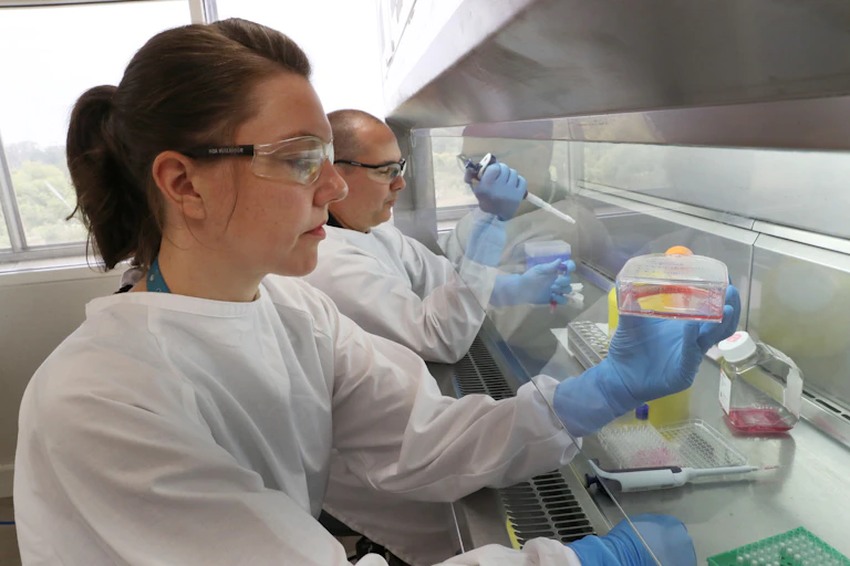 Female and male scientists working at a lab bench