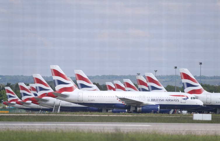 British Airways planes parked on an airport runway