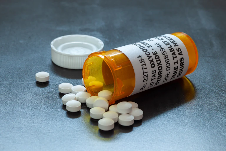 Painkillers spilling from a bottle