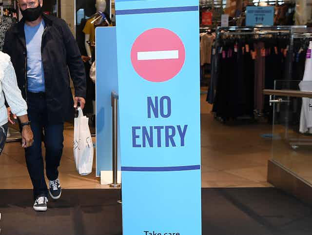 No entry sign in the doorway of a shop using a one-way system.